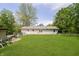 Expansive backyard with lush lawn, mature trees, and partial fence offers privacy and space at 503 E Bunker Hill Rd, Mooresville, IN 46158