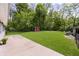 Large, well-maintained backyard with mature trees, sheds, and a concrete patio at 503 E Bunker Hill Rd, Mooresville, IN 46158