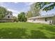 Well-manicured backyard with mature trees, large lawn, a shed, and a small patio at 503 E Bunker Hill Rd, Mooresville, IN 46158