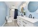 Bright bathroom with dual sinks, modern lighting, subway tile shower, and a gray tile floor at 503 E Bunker Hill Rd, Mooresville, IN 46158