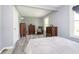 Gray walls highlight this bedroom with wood-look flooring and traditional dressers and chair at 503 E Bunker Hill Rd, Mooresville, IN 46158