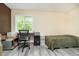 Neutral-toned bedroom or office space featuring a desk, laminate flooring, and a window at 503 E Bunker Hill Rd, Mooresville, IN 46158