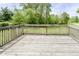 View of a wooden deck surrounded by lush greenery and trees, perfect for outdoor relaxation at 503 E Bunker Hill Rd, Mooresville, IN 46158
