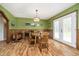 Charming dining room featuring a wooden table, natural light, and access to the outdoors through French doors at 503 E Bunker Hill Rd, Mooresville, IN 46158