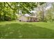 A charming home with a large manicured lawn and a covered porch perfect for relaxing in a serene setting at 503 E Bunker Hill Rd, Mooresville, IN 46158