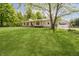 Charming home with a large front yard, mature tree, covered porch with a porch swing and an attached garage at 503 E Bunker Hill Rd, Mooresville, IN 46158