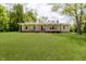 Charming home with a well-manicured lawn, covered porch with a porch swing and an eye-catching red front door at 503 E Bunker Hill Rd, Mooresville, IN 46158