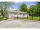 Home exterior features a fenced yard with a small concrete patio and steps leading to the back door at 503 E Bunker Hill Rd, Mooresville, IN 46158