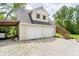 Two-car garage with a wooden staircase leading to a second level or loft area at 503 E Bunker Hill Rd, Mooresville, IN 46158