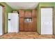 The kitchen has a white refrigerator with a built-in cabinet and wood-look laminate floor at 503 E Bunker Hill Rd, Mooresville, IN 46158