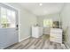Bright laundry room features modern washer, dryer, water heater, and wood look tile flooring at 503 E Bunker Hill Rd, Mooresville, IN 46158