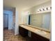 Bathroom featuring dual sinks, a large mirror, and a shower-tub combo at 5313 Brandywine Dr, Whitestown, IN 46075