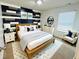 Stylish bedroom with a modern accent wall, natural wood furniture, and bright natural light at 5313 Brandywine Dr, Whitestown, IN 46075