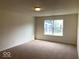 Well-lit bedroom with neutral carpeting, a window and electrical outlets throughout at 5313 Brandywine Dr, Whitestown, IN 46075
