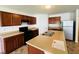 Kitchen with island sink, stainless steel refrigerator, and wooden cabinets at 5313 Brandywine Dr, Whitestown, IN 46075