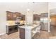 Modern kitchen boasts stainless steel appliances, light countertops, and an island with seating, perfect for entertaining guests at 5313 Brandywine Dr, Whitestown, IN 46075