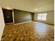 Spacious living room with modern gray accent wall and luxury vinyl tile at 5313 Brandywine Dr, Whitestown, IN 46075