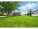 Expansive backyard showcasing a well-maintained lawn and mature trees at 532 W 1050 N, Fortville, IN 46040