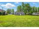 Large backyard with green grass and mature trees, perfect for outdoor activities at 532 W 1050 N, Fortville, IN 46040