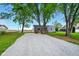 Inviting home featuring a spacious gravel driveway and mature trees at 532 W 1050 N, Fortville, IN 46040