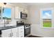 Kitchen showcasing stainless steel appliances, subway tile backsplash, and natural light from the windows at 532 W 1050 N, Fortville, IN 46040