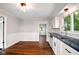 Bright kitchen featuring white cabinetry, a stainless steel dishwasher, and modern lighting at 532 W 1050 N, Fortville, IN 46040