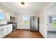 Bright kitchen featuring white cabinets, stainless steel appliances, and wood-look flooring at 532 W 1050 N, Fortville, IN 46040