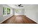Spacious living room with beautiful windows, ceiling fan, and hardwood floors at 532 W 1050 N, Fortville, IN 46040