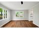 Bright living room featuring hardwood floors, a ceiling fan and views from the windows at 532 W 1050 N, Fortville, IN 46040