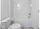 A bright white bathroom with a standard tub and shower combination at 558 Plowman Dr, Shelbyville, IN 46176