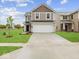Beautiful two-story home featuring a spacious driveway, manicured lawn, and classic architectural details at 558 Plowman Dr, Shelbyville, IN 46176