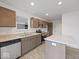 Modern kitchen featuring stainless steel appliances, granite countertops, and ample cabinet space, with a center island at 558 Plowman Dr, Shelbyville, IN 46176