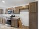 Modern kitchen featuring stainless steel appliances, granite countertops, and ample cabinet space at 558 Plowman Dr, Shelbyville, IN 46176