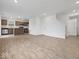 Bright open-concept living space showcasing wood floors, white walls, and access to the kitchen and stairs at 558 Plowman Dr, Shelbyville, IN 46176