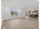 Bright open-concept living space showcasing wood floors, large windows, and a glimpse of the modern kitchen at 558 Plowman Dr, Shelbyville, IN 46176