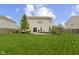 Spacious backyard features a well-maintained lawn, a patio and grill area perfect for entertaining at 5593 Ralfe Rd, Indianapolis, IN 46234
