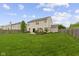Expansive backyard with a lush green lawn, patio area, and thoughtful landscaping for outdoor enjoyment at 5593 Ralfe Rd, Indianapolis, IN 46234