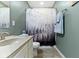 Charming bathroom featuring a modern sink, decorative shower curtain, and neutral color palette at 5593 Ralfe Rd, Indianapolis, IN 46234