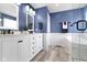 Bright bathroom with double vanity, marble countertop, decorative fixtures, and a soaking tub at 5593 Ralfe Rd, Indianapolis, IN 46234