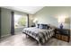 Light-filled bedroom featuring a window, neutral walls, and a cozy plaid bedspread at 5593 Ralfe Rd, Indianapolis, IN 46234