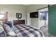Cozy bedroom features a dresser, TV, and en-suite bath with barn-style door at 5593 Ralfe Rd, Indianapolis, IN 46234