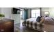 Well-appointed bedroom with plank flooring, a sliding barn door, and streaming sunlight at 5593 Ralfe Rd, Indianapolis, IN 46234