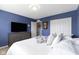 Comfortable bedroom with white bedding, neutral colors, a dresser, and bright overhead lighting at 5593 Ralfe Rd, Indianapolis, IN 46234