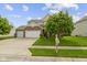 Attractive two-story home boasts a three car garage, stone details, green lawn, and a welcoming mailbox at 5593 Ralfe Rd, Indianapolis, IN 46234