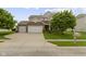Beautiful two-story home with a three car garage, stone accents, landscaped yard, and a mailbox at 5593 Ralfe Rd, Indianapolis, IN 46234