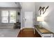 Bright foyer with hardwood floors, a white front door, and elegant decor at 5593 Ralfe Rd, Indianapolis, IN 46234