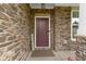 Warm front porch showcasing stone details, a 'Welcome' sign, and a well maintained front at 5593 Ralfe Rd, Indianapolis, IN 46234