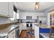 Well-lit kitchen with white cabinets, stainless appliances, and warm brown countertops at 5593 Ralfe Rd, Indianapolis, IN 46234
