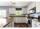 Updated kitchen features stainless steel appliances, plentiful counter space, and an eat-in breakfast nook at 5593 Ralfe Rd, Indianapolis, IN 46234