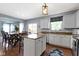 Open-concept kitchen and dining area with a center island and hardwood floors at 5593 Ralfe Rd, Indianapolis, IN 46234